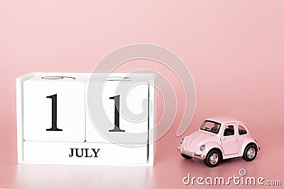 July 11th. Day 11 of month. Calendar cube on modern pink background with car Stock Photo