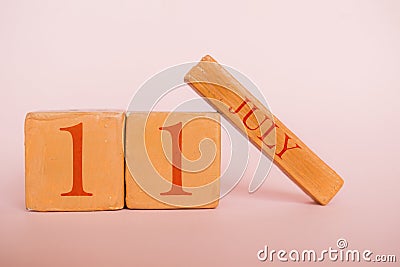 july 11th. Day 11 of month, handmade wood calendar on modern color background. summer month, day of the year concept Stock Photo