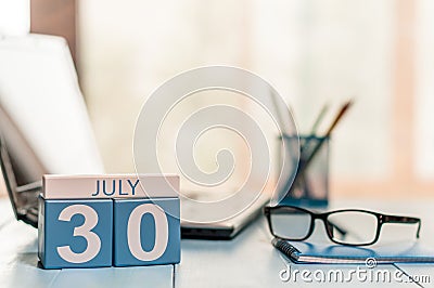 July 30th. Day 30 of month, wooden color calendar on business workplace background. Summer time. Empty space for text Stock Photo