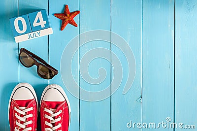 July 4th. Image of july 4 wooden color calendar on blue background. Summer day. Empty space for text. Independence Day Stock Photo