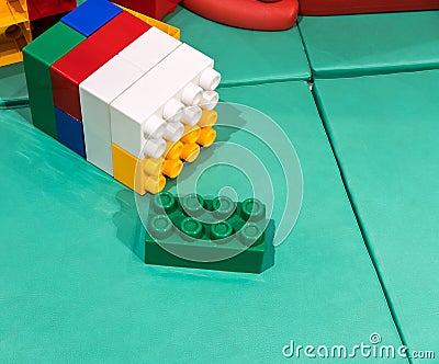 Jumbo building blocks on leather mat for fun playtime. Stock Photo