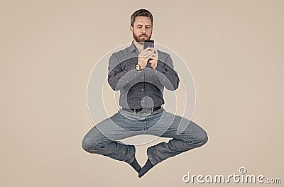 jump ceo meditating online. sms and instant messaging. yoga energetic businessman chat online. Stock Photo
