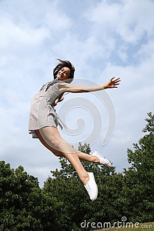 Jump for happy success by beautiful woman Stock Photo