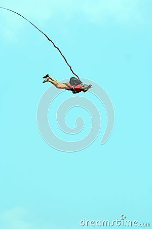 Jump off a cliff with a rope. Stock Photo