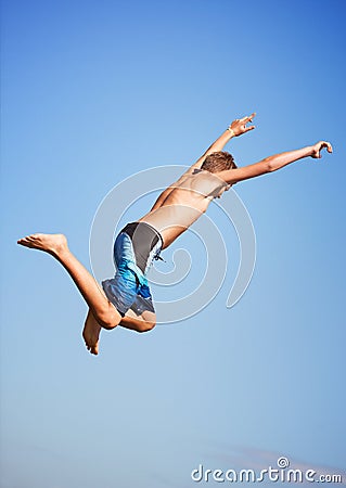 Jumping, blue sky and man with energy, outdoor and excited with nature, environment and water. Person, outside and guy Stock Photo