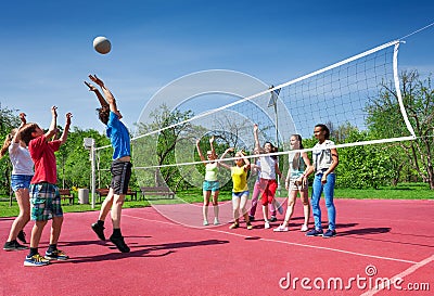 Jumping boy during volleyball game on the court Stock Photo