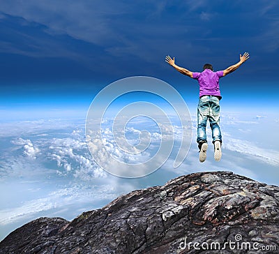 Jumping off a mountain cliff Stock Photo