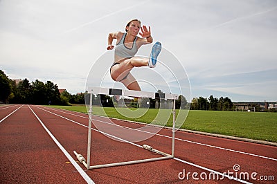 Jumping over a hurdle Stock Photo