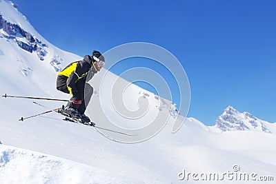 Jumping skier at mountains Stock Photo