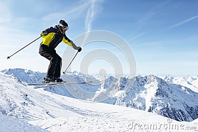 Jumping skier at mountains Stock Photo
