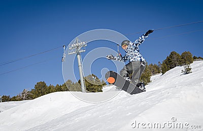 Jumping snowboarder with a blue and sunny sky in Zermatt, the swiss Alps Editorial Stock Photo