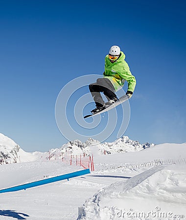 Jumping snowboarder with a blue and sunny sky in Zermatt, the swiss Alps Editorial Stock Photo