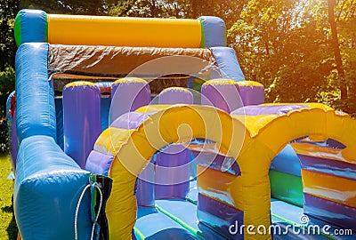 Jumps on a big inflatable trampoline Stock Photo