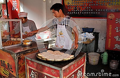 Jun Le, China: Chefs Making Chinese Pizzas Editorial Stock Photo