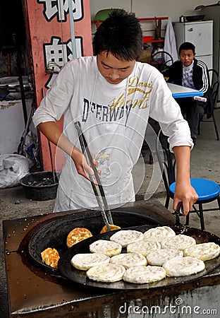 Jun Le, China: Cooking Chinese Pizza Editorial Stock Photo