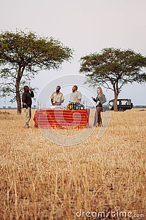 Safari outdoor picnic with beverage bar in Savanna field of Serengeti forest Editorial Stock Photo