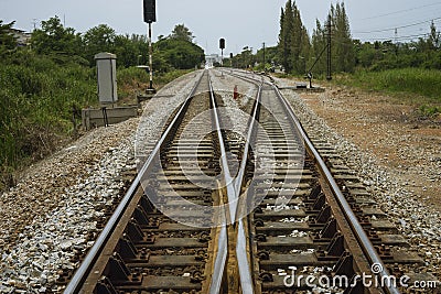 Junction of railway track with green tree at left and right side of railway.filtered image.choose for life concept.choice of life Stock Photo