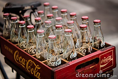 2020 June Bangkok Thailand. Vintage Coca-Cola clear glass bottle in Red Plastic Box carry on bicycle Editorial Stock Photo