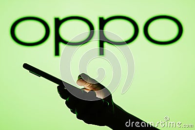 June 13, 2023, Brazil. OPPO logo seen in the background of a silhouette woman holding a mobile Cartoon Illustration