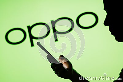 June 13, 2023, Brazil. Oppo logo is seen in the background of a silhouetted woman holding a mobile Cartoon Illustration