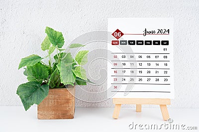 June 2024 calendar page and wooden plant pot Stock Photo