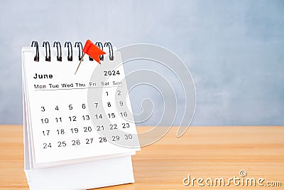 June 2024 calendar and red push pin on table Stock Photo