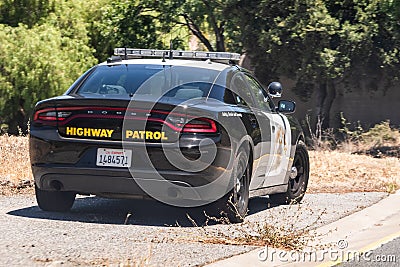 June 14, 2020 Mountain View / CA / USA - Highway Patrol vehicle parked on the left side of a freeway entrance; The California Editorial Stock Photo