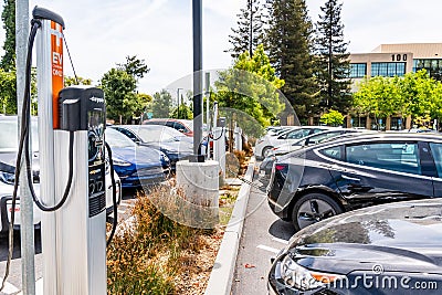 June 24, 2019 Mountain View / CA / USA - Various brands of electric and hybrid vehicles parked at a busy charging station in south Editorial Stock Photo