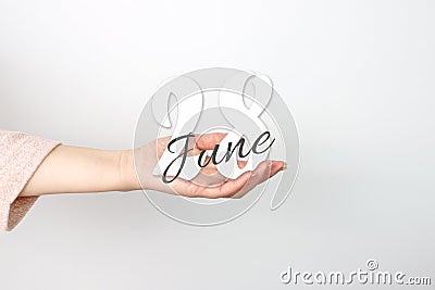 June 28th. Day 28 of month, Calendar date. Calendar Date floating over female hand on grey background. Summer month, day of the Stock Photo
