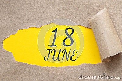 june 18. 18th day of the month, calendar date.Hole in paper with edges torn off. Yellow background is visible through Stock Photo