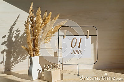 june 1. 1th day of month, calendar date. White vase with dead wood next to the numbers 2022 and stand with an empty Stock Photo