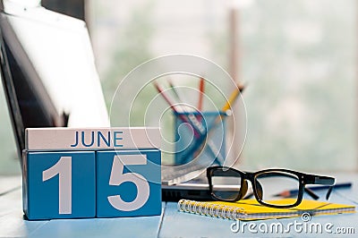 June 15th. Day 15 of month, wooden color calendar on freelance workplace background. Summer time. Empty space for text Stock Photo