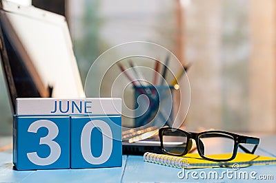 June 30th. Day 30 of month, wooden color calendar on manager workplace background. Summer time. Empty space for text Stock Photo