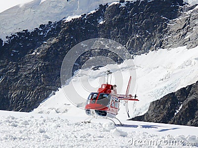 Jungfrau, Switzerlan. Red helicopter on high mountain snow Editorial Stock Photo