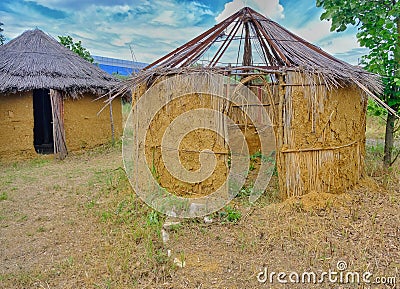 Jungle bamboo houses with their roofs made of plant or tree branches Stock Photo