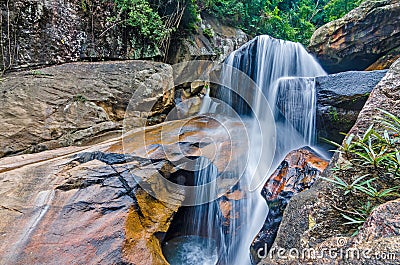 Jungle waterfall with flowing water, large rocks Stock Photo