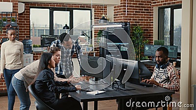 Junior dev programmers collaborating on group project compiling algorithm asking senior developer for help Stock Photo