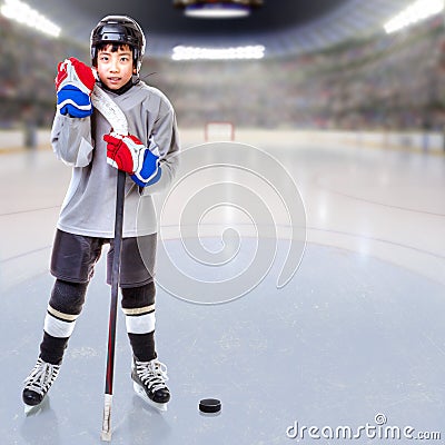 Junior Ice Hockey Player Posing in Arena Stock Photo