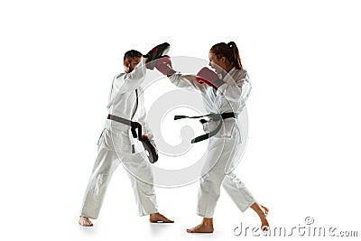 Junior in kimono practicing hand-to-hand combat with coach, martial arts Stock Photo