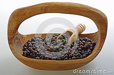 Juniper berry in a wooden bowl. Stock Photo