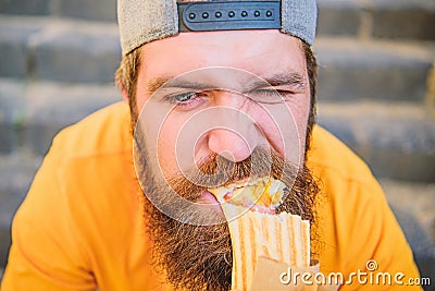 Junk food. Snack for good mood. Unleashed appetite. Street food concept. Man bearded eat tasty sausage. Urban lifestyle Stock Photo