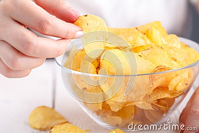 Junk unhealthy food, heap of potato chipa in big dish Stock Photo