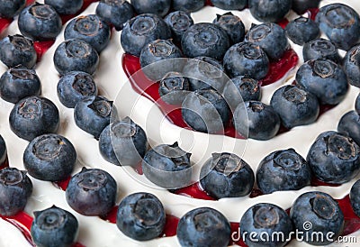 Junket with big blueberries and red cherry jam Stock Photo