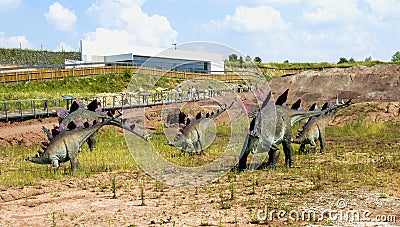 JuraPark dinosaur park, figures of a herd of grazing stegosaurs Editorial Stock Photo