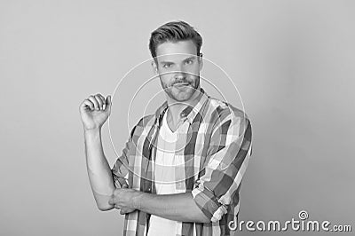 Just cool dude. Handsome dude portrait. Young man roll up shirt sleeves. Serious guy yellow background Stock Photo