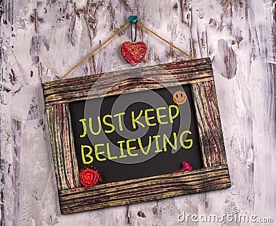 Just keep believing written on Vintage sign board Stock Photo