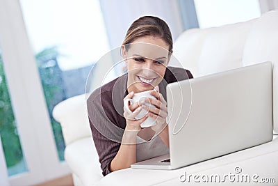 Just a movie date with my laptop. a beautiful young woman using her laptop at home. Stock Photo