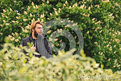 Just one more ordinary male face portrait middle adult age with beard in nature park land outdoors space in spring time Stock Photo