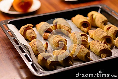 Just out of the oven, freshly baked mini croissants with a crispy crust Stock Photo