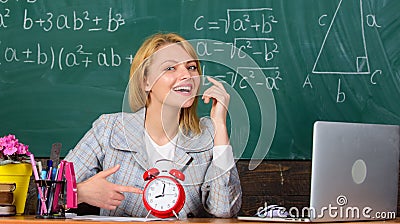 Just in time. teacher with alarm clock at blackboard. Time. woman in classroom. Back to school. Teachers day. Study and Stock Photo
